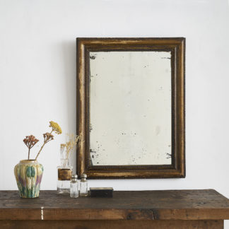 Ancien miroir, encadrement en bois à la patine vieil or